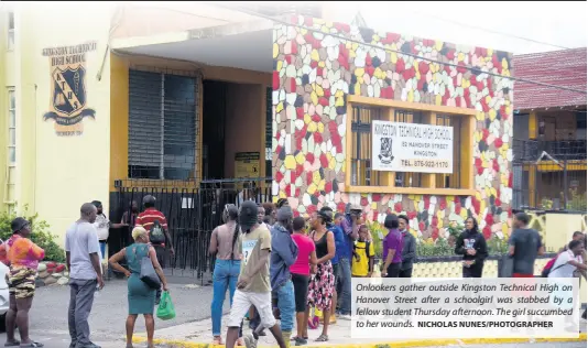  ?? NICHOLAS NUNES/PHOTOGRAPH­ER ?? Onlookers gather outside Kingston Technical High on Hanover Street after a schoolgirl was stabbed by a fellow student Thursday afternoon. The girl succumbed to her wounds.
