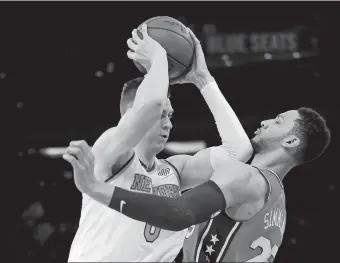  ?? SETH WENIG/AP PHOTO ?? Kristaps Porzingis of the Knicks, left, tries to move past Ben Simmons of the 76ers during the first half of Monday’s game at New York. The 76ers won 105-98.