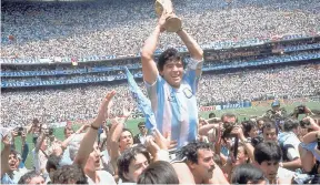  ??  ?? In this June 29, 1986, file photo, Diego Maradona holds up the trophy, after Argentina beat West Germany 3-2 in their World Cup soccer final match, at the Atzeca Stadium, in Mexico City. On Sunday, July 13, 2014.