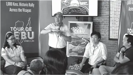  ?? (Photo taken during the Tour de Cebu 2015 press conference held on August 7, 2015) ?? Formula 3 Champ and ProDynamic Management Inc.'s Pepon Marave (standing) relays the rally route of the forthcomin­g Tour de Cebu 2015 — a 1000 KM rally that will cover Cebu and Negros Island this October 3 to 5. Together with Marave is Tour de Cebu...