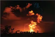  ?? (AP/National Park Service/Janice Wei) ?? People watch the eruption of Hawaii’s Kilauea volcano Sunday night on the Big Island.