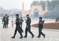  ?? NG HAN GUAN THE ASSOCIATED PRESS FILE PHOTO ?? Uighur security personnel patrol near the Id Kah Mosque in Kashgar in China’s western Xinjiang region. Many Arab countries have benefited from investment while remaining silent on China’s handling of its Muslim minority, writes Tony Burman.