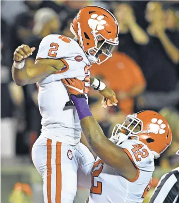  ?? JAMIE RHODES, USA TODAY SPORTS ?? While giving Clemson a big lift in his first three starts, quarterbac­k Kelly Bryant got a lift from defensive lineman Christian Wilkins after a TD on Saturday.