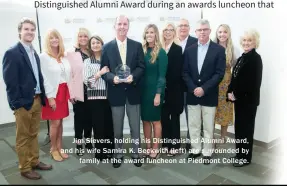  ??  ?? Jim Sievers, holding his Distinguis­hed Alumni Award, and his wife Samira K. Beckwith (left) are surrounded by family at the award luncheon at Piedmont College.