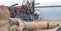  ??  ?? Workers drill a new well on a farm in California’s Tulare County in 2015.