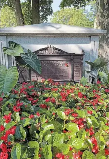  ??  ?? Begonias and elephant ears surround the memorial to Westinghou­se workers who served in wartime.