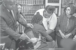  ?? NICK OZA/THE REPUBLIC ?? Community activist the Rev. Jarrett Maupin shows Edward Brown’s bullet wounds at a press conference on Sept. 24, 2018. Brown is paralyzed from the chest down after being shot by a Phoenix police officer.