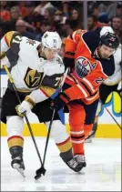  ?? The Canadian Press ?? Edmonton Oilers’ Leon Draisaitl battles Vegas Golden Knights’ William Karlsson in Edmonton on Monday.