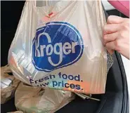  ?? AP FILE PHOTO/ROGELIO V. SOLIS ?? A customer removes her purchases at a Kroger grocery store in Flowood, Miss.