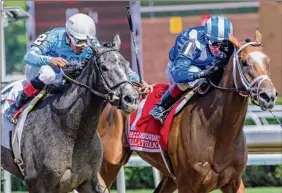  ?? Skip Dickstein / Special to the Times Union ?? Maracuja, left, with jockey Ricardo Santana Jr., passes Malathaat with jockey John Velazquez to win the CCA Oaks at Saratoga on July 24.