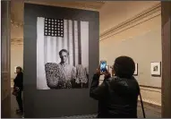  ?? AP/J. SCOTT APPLEWHITE ?? Jessica White of San Francisco on Tuesday photograph­s the 1942 picture American Gothic by photojourn­alist, musician, writer and film director Gordon Parks on display at the National Gallery of Art in Washington. Her father, artist Charles White, was a friend of Parks and was the subject of one of the photos in the exhibit.