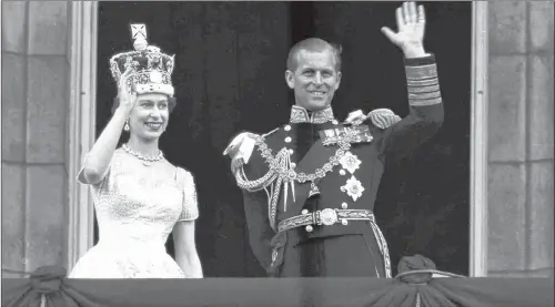  ?? LESLIE PRIEST/AP FILE PHOTO ?? In this June 2, 1953 file photo, Queen Elizabeth II and Prince Philip, Duke of Edinburgh, wave to supporters from the balcony at Buckingham Palace, following her coronation at Westminste­r Abbey. Philip retired from solo official duties on Wednesday at...