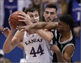  ?? CHARLIE RIEDEL — THE ASSOCIATED PRESS ?? Emporia State’s Marquis McCray, right, tries to steal the ball from Kansas’ Mitch Lightfoot (44) during an exhibition game Wednesday in Lawrence, Kan.