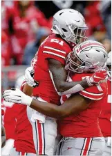  ??  ?? Parris Campbell (left) celebrates with teammates after a 16-yard touchdown reception against Rutgers.