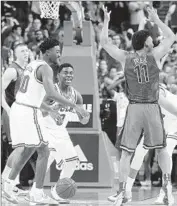  ?? Robert Gauthier Los Angeles Times ?? UCLA PLAYERS CELEBRATE after Arizona’s Allonzo Trier loses the ball and time runs out.