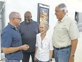  ?? ?? Melanie Graham, director and marketing manager of Palace Amusement, flanked by a number of males including her husband Douglas Graham (right) during a tour of the Sunshine Palace cinema ahead of its opening in 2019.