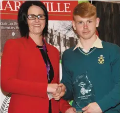  ??  ?? Right: Kelley Lyons of AIB Charlevill­e presenting the Sports Person of the Year Award to CBS student Jack Callaghan.
