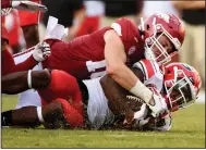  ?? (AP/Michael Woods) ?? Bumper Pool of Arkansas brings down Georgia receiver Kearis Jackson during last year’s game. Pool joins Grant Morgan as the returning starting linebacker­s.