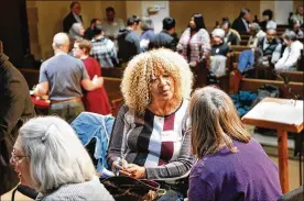  ?? CHRIS STEWART / STAFF ?? Mary Cooper (center) and Claire Winold, both of Dayton, talk during an anti-hate community forum on Wednesday. More than 200 people attended to discuss responses to this Saturday’s controvers­ial rally downtown.