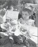  ?? RAINA HANNA/SPECIAL TO THE COMMERCIAL
APPEAL ?? Natalia Ingelmo 2½ eyes some cinnamon basil at Bobby Lanier Farm Park in Germantown, where special events are held for children each Friday.