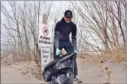 ?? BRIANA CONTRERAS — THE MORNING JOURNAL ?? Lorain resident Emiliano Moreno, 16, helps pick up trash on the beach of Lakeview Park, 1800 W Erie Ave. in Lorain, during the park’s annual Earth Day Park & Beach Clean Up April 21. Emiliano said he found and collected plastic cups, other plastic...