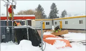  ?? RON SEYMOUR/The Daily Courier ?? Workers prepare trailers Wednesday that will serve as a 40-bed emergency shelter for homeless people on Stevens Road in West Kelowna.