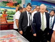  ??  ?? Prime Minister Ranil Wickremesi­nghe, Ministers Amarathung­e and Bathiudeen inspect merchandis­e on display at the new store.
Pic by Pradeep Pathirana