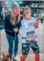  ?? ?? Erin Azar, right, stops to take a selfie with a Mrs. Space Cadet fan in the middle of the New York City Marathon.
