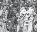  ?? BENNY SIEU/USA TODAY SPORTS ?? Brewers shortstop Willy Adames, right, reacts after hitting a two-run home run in the eighth inning as Reds catcher Tyler Stephenson watches on Thursday.