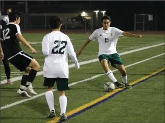  ?? Haley Sawyer/The
Signal (See additional photos on signalscv.com) ?? Canyon boys soccer’s Samuel Zometa keeps the ball from going out of bounds against Calabasas on Friday night at Canyon. The Cowboys shut out the Coyotes 2-0.