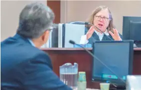  ?? EDDIE MOORE/JOURNAL ?? First Judicial District Judge Sarah Singleton, right, asks Paul Aguilar of the Public Education Department to further explain an answer during Friday’s court session.