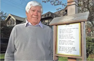  ?? PAT A. ROBINSON / FOR THE MILWAUKEE JOURNAL SENTINEL ?? Harvey “Buzz” Wickman Jr. stands next to his poetry post outside his home in Shorewood on Friday. Wickman installed the post in his front yard and puts up a different poem every few days.