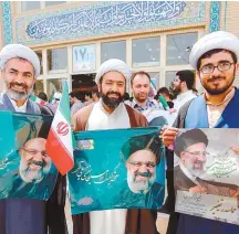  ?? AFP-Yonhap ?? Supporters of Iranian presidenti­al candidate Ebrahim Raisi hold his portrait outside a campaign rally at Imam Khomeini Mosque in the capital Tehran, Iran, Tuesday.