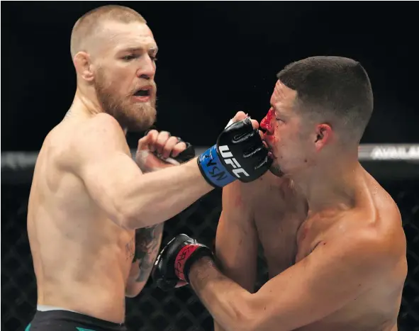  ?? — GETTY IMAGES FILES ?? Conor McGregor hits Nate Diaz with a right during their welterweig­ht rematch at UFC 202 in Las Vegas last August.