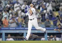  ?? MARCIO JOSE SANCHEZ — THE ASSOCIATED PRESS ?? The Dodgers’ Max Muncy points skyward as he reaches home plate following his solo home run during the first inning Monday night.