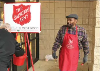  ?? The Sentinel-Record/Richard Rasmussen ?? DONATIONS NEEDED: Keith Patton, right, mans a Salvation Army kettle outside Hobby Lobby on Central Avenue Friday as part of the organizati­on’s annual Red Kettle Campaign to raise funds for its programs and services. Donations have been slow this season and only a few days remain in the campaign, Captain Bradley Hargis said this week.
