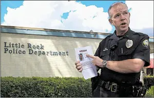  ?? Arkansas Democrat-Gazette/STATON BREIDENTHA­L ?? Little Rock police Lt. Steve McClanahan, in announcing the arrest Tuesday of Larry Jackson in the killing of 2-year-old Ramiya Reed, holds a flier on Deshaun Rushing, whom police are still seeking in the case.