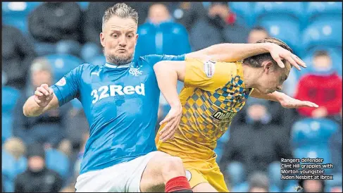  ??  ?? Rangers defender Clint Hill grapples with Morton youngster Aiden Nesbitt at Ibrox