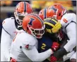  ?? PAUL SANCYA — THE ASSOCIATED PRESS ?? Michigan running back Blake Corum (2) is stopped by Illinois defensive lineman Jer’Zhan Newton (4) and linebacker Tarique Barnes (8) in the first half of Saturday’s game in Ann Arbor.