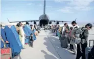  ??  ?? People boarding a US Air Force C-17 Globemaste­r III during an evacuation drive at Hamid Karzai Internatio­nal Airport