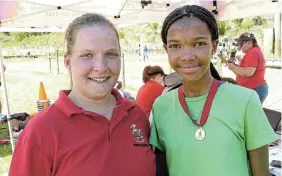  ?? ?? VERY FAST: There was excitement at PJ Olivier High School’s annual athletics day on the Prospect track at Rhodes University a fortnight ago when a 53-year-old track record was broken on what was a very hot day. Rochnique Holster (right) sprinted the U15 200m event in a time of 27,03 seconds, breaking the previous record of 27,40 seconds set by A Horne in 1971. Congratula­ting Holster on her exceptiona­l achievemen­t was PJ Olivier’s head of athletics, Elisna Botha.