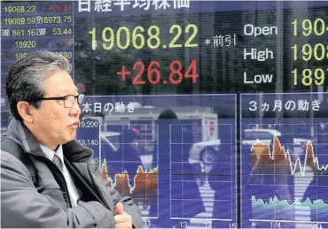  ?? PHOTO: AP ?? An electronic stock indicator in Tokyo yesterday. Shares were modestly higher in Asia after Wall Street steadied overnight. Investors are awaiting a vote in the US Congress on health-care legislatio­n.