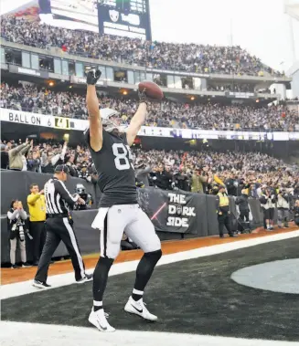  ?? Scott Strazzante / The Chronicle ?? Raiders tight end Derek Carrier exults after catching a 6-yard touchdown on 4th-and-goal in the final minute to help pull out a victory over the Steelers.