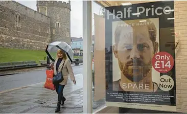  ?? DAN KITWOOD/GETTY ?? Prince Harry’s book “Spare” is advertised this week by a shop opposite Windsor Castle in England.