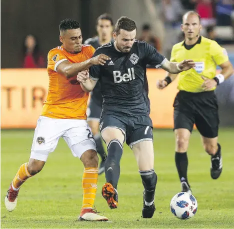  ?? TROY TAORMINA/USA TODAY SPORTS/VANCOUVER WHITECAPS ?? Whitecaps midfielder Jordon Mutch, centre, played 20 minutes in his Vancouver debut March 10 against defender Darwin Ceren and the Houston Dynamo, a 2-1 Caps win. Mutch says he will accept whatever role he’s given this season.