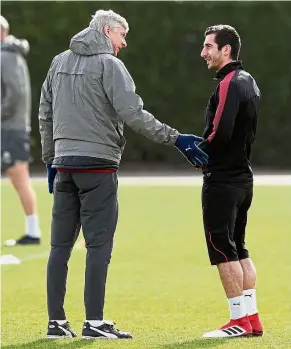  ?? — Reuters ?? Calm before the storm: Arsenal manager Arsene Wenger (left) speaking with Henrikh Mkhitaryan during a training session at the Arsenal Training Centre in St Albans yesterday.