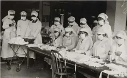  ?? COURTESY NATIONAL ARCHIVES ?? THEN VS. NOW: Red Cross workers make anti-influenza masks for soldiers in camp in Boston.