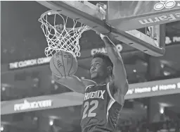  ??  ?? Suns center Deandre Ayton dunks against the Golden State Warriors on Monday night at Oracle Arena.