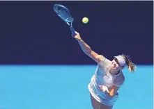  ?? VINCENT THIAN/ASSOCIATED PRESS ?? Maria Sharapova serves to Tatjana Maria during their first-round match today. Sharapova won in straight sets.