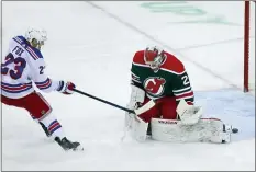  ?? ANDREW MILLS — NJ ADVANCE MEDIA VIA AP ?? Rangers defenseman Adam Fox (23) beats Devils goaltender Mackenzie Blackwood (29) to score during the first period in Newark on Saturday.